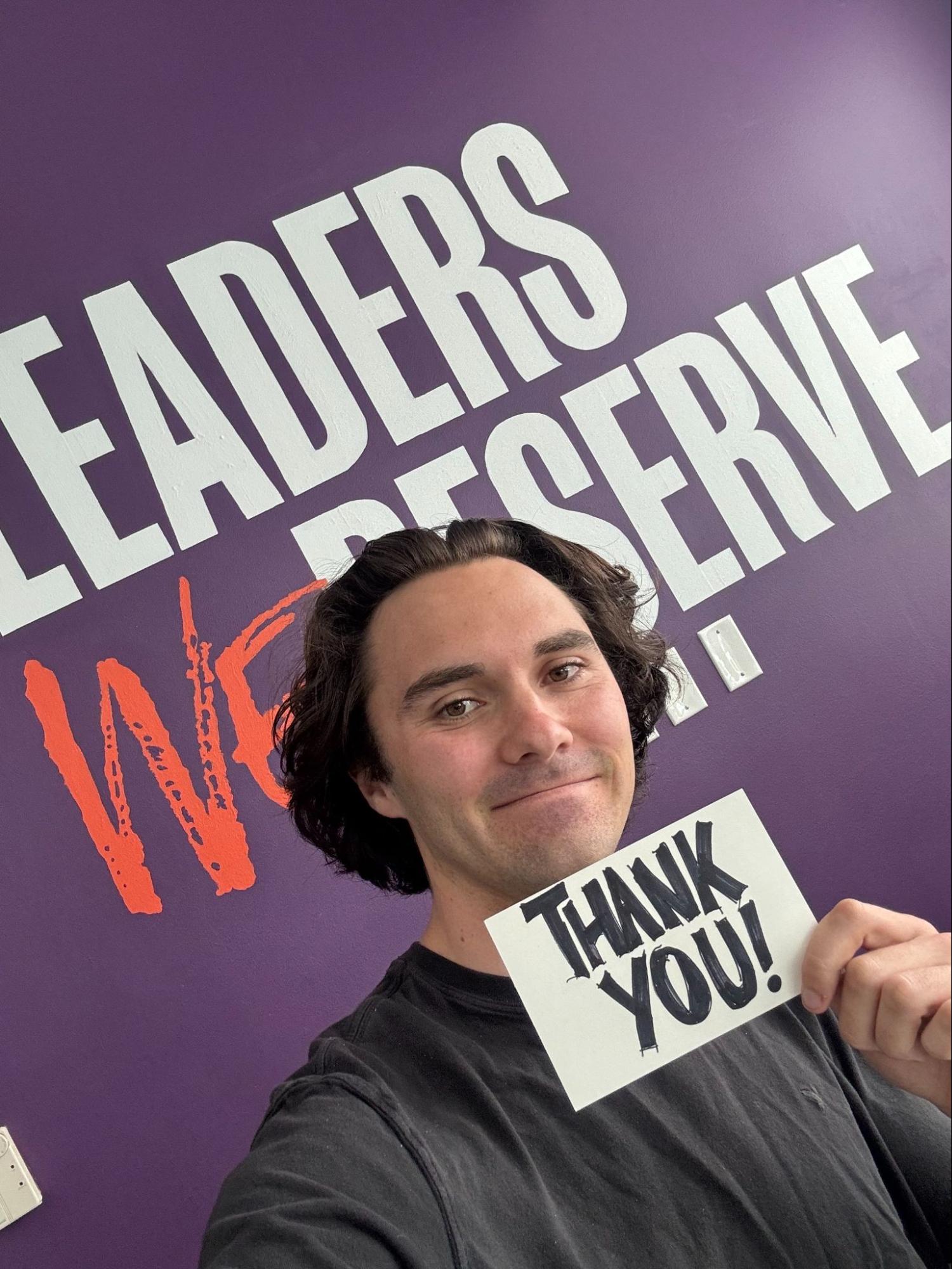 David Hogg holding up a thank you card
